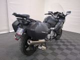 a motorcycle that is parked in a room with a checkered floor