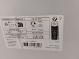 the back of a white refrigerator freezer with a label on it