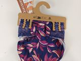 purple and pink floral shorts with a wooden hanger on a white background