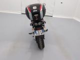 a motorcycle parked in a room with a helmet on it ' s head