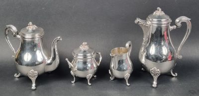 four pieces of silver tea and coffee set on a table