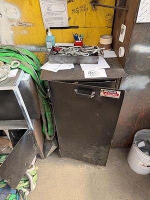 an image of a dirty kitchen with a dishwasher and a trash can