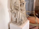 a statue of a woman holding a child on a pedestal