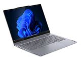 l'ordinateur portable est ouvert sur une surface blanche avec un fond bleu