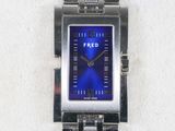 a silver watch with a blue face on a white surface