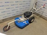 an image of a small lawn mower in a room