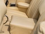a red convertible car with beige leather seats and a black steering wheel