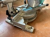 someone is using a circular saw to cut a piece of wood