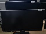 a computer desk with three monitors and a laptop on it