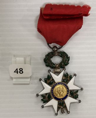 une image représentant une médaille ornée d'un ruban rouge et d'une étoile