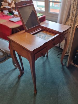 a small desk with a laptop on top of it