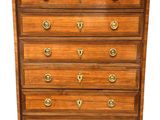 an antique wooden chest of drawers with brass hardware