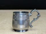 a silver cup that is sitting on a table