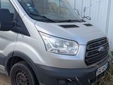 a silver van parked in front of a white building