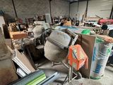 a lot of junk in a warehouse with a green door