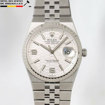 une montre en argent avec un cadran blanc