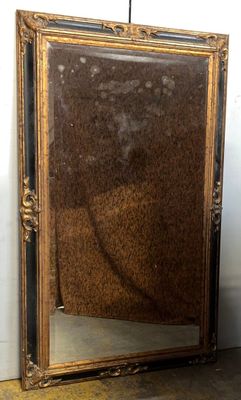 a mirror that is sitting on the floor next to a wall