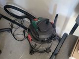 a vacuum that is sitting on the floor next to a box