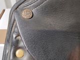 a close up of a black purse with gold buttons on it