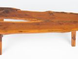 a wooden bench that is made of wood and has two legs