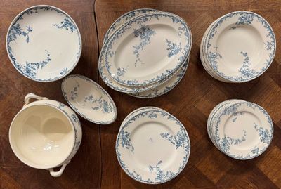 several pieces of blue and white china sitting on a wooden table