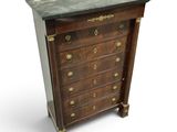 an antique chest of drawers with marble top and brass handles