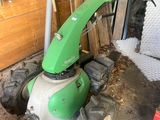 a green and white machine that is in a garage