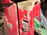a red fire hydrant sitting in the middle of a pile of junk