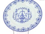 a blue and white plate with a picture of a man and woman on it
