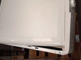 a white refrigerator sitting on top of a wooden pallet