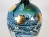 a glass vase with a blue and gold design on it