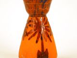 un vase orange orné d'un motif de palmier