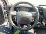 a steering wheel and dashboard of a vehicle in a parking lot