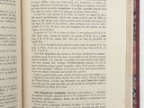 an open book on a white table with a red border