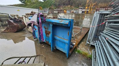 a dumpster that is sitting in the middle of a lot