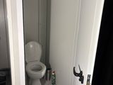a toilet in the corner of a small bathroom