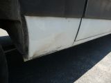 a close up of a flat tire on the side of a truck