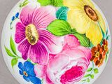 a white plate with colorful flowers painted on it
