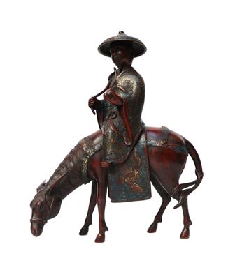 statue of a man riding a horse with a hat on his head