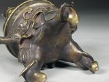 bronze figurine of an elephant with a saddle on it ' s back