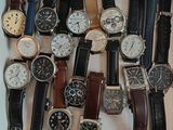 many different types of watches in a white box