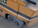 a forklift that is sitting on the side of the road