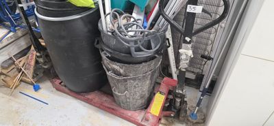a pile of trash in a garage with a lot of tools