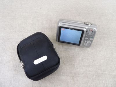 a small camera and a small case on the floor
