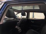 the interior of a car with a sunroof and black leather seats