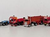 many toy cars lined up in a row on a white surface