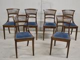 six chairs that are lined up in a row