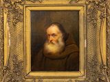 a painting of an old man with a beard in a gold frame