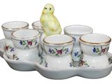 a small tray with cups and a bird on it