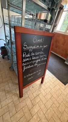 a chalk board with a menu on it in a restaurant